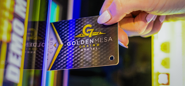 Close-up of a guest inserting a Golden Mesa Players Club card into an electronic game at Golden Mesa Casino.