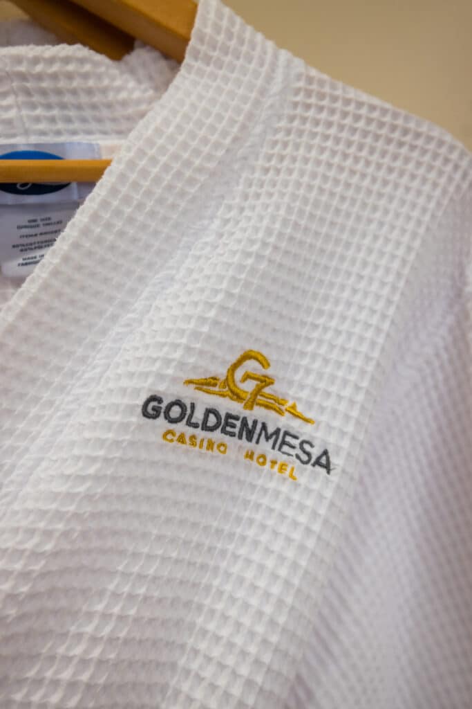White waffle robe with embroidered Golden Mesa Casino & Hotel logo, available in Golden Mesa Hotel suites.