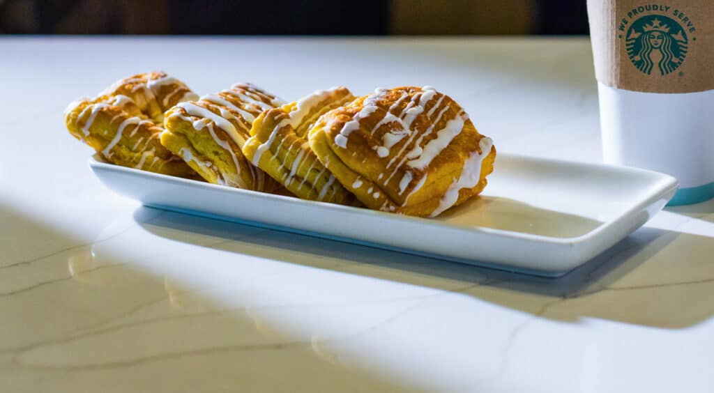 Iced cinnamon rolls served on a white platter at Panhandle Press Coffee Shop inside Golden Mesa Casino & Hotel.
