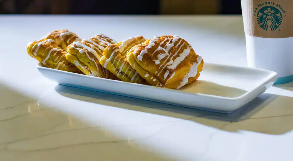 Iced cinnamon rolls served on a white platter at Panhandle Press Coffee Shop inside Golden Mesa Casino & Hotel.