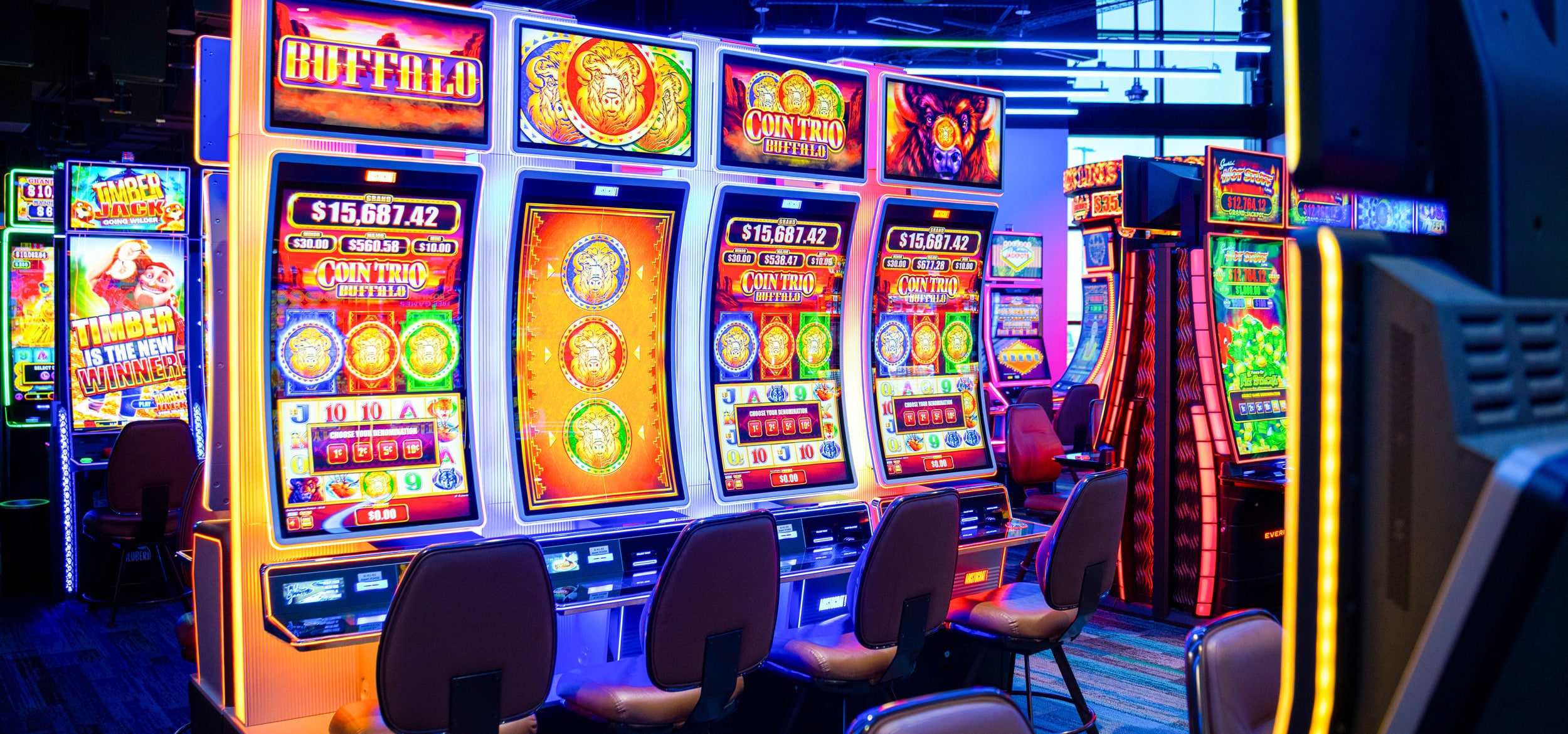Bright electronic games and slot machines glowing with colorful screens on the Golden Mesa Casino gaming floor.