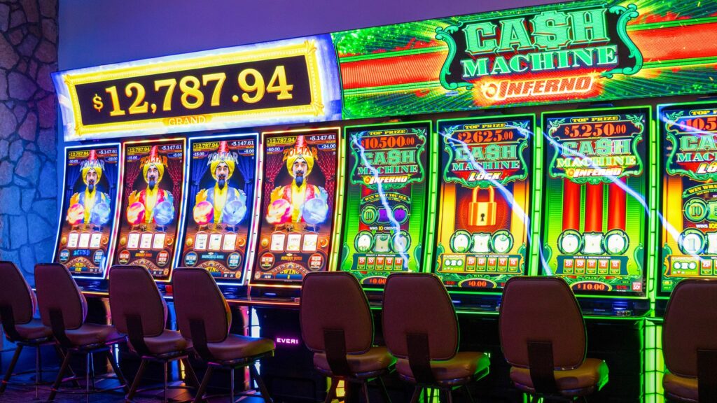 Bright Cash Machine and Zoltar slot machines with large jackpot screens on the Golden Mesa Casino gaming floor.