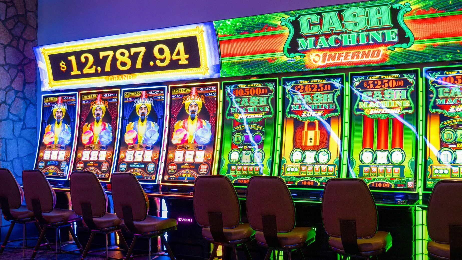 Bright Cash Machine and Zoltar slot machines with large jackpot screens on the Golden Mesa Casino gaming floor.