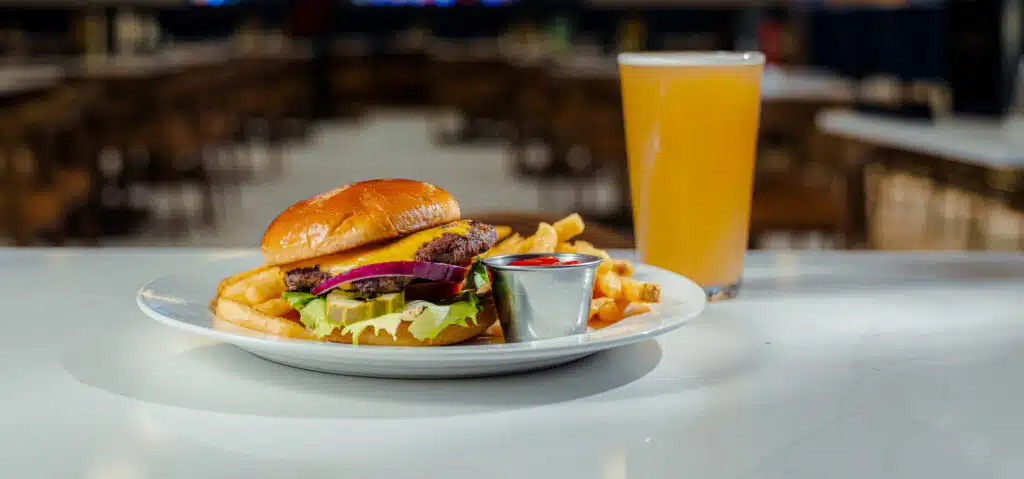 Cheeseburger with fries and a pint of beer served on the bar at Cimarron Ridge Restaurant inside Golden Mesa Casino & Hotel.
