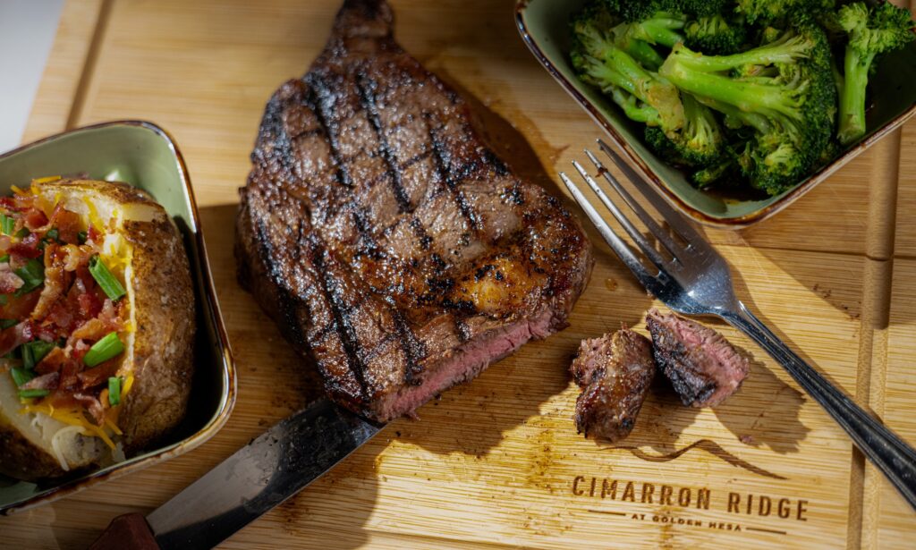 Grilled steak with baked potato and broccoli served at Golden Mesa's Cimarron Ridge Restaurant.