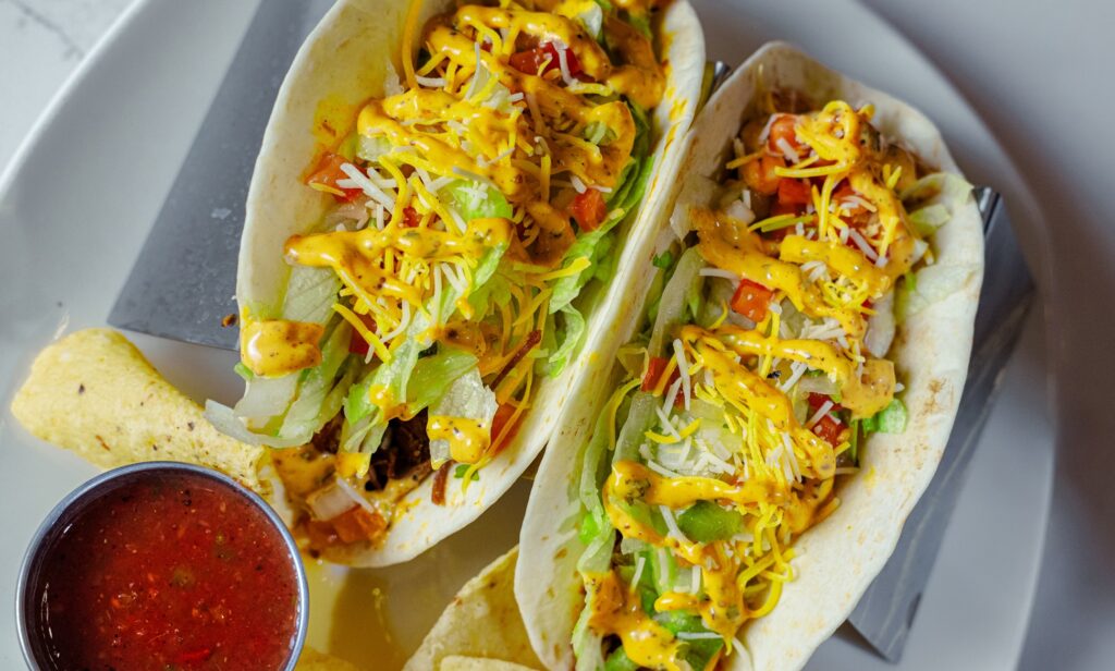 Two tacos with lettuce, cheese, salsa and chips served at Cimarron Ridge Restaurant inside Golden Mesa Casino & Hotel.