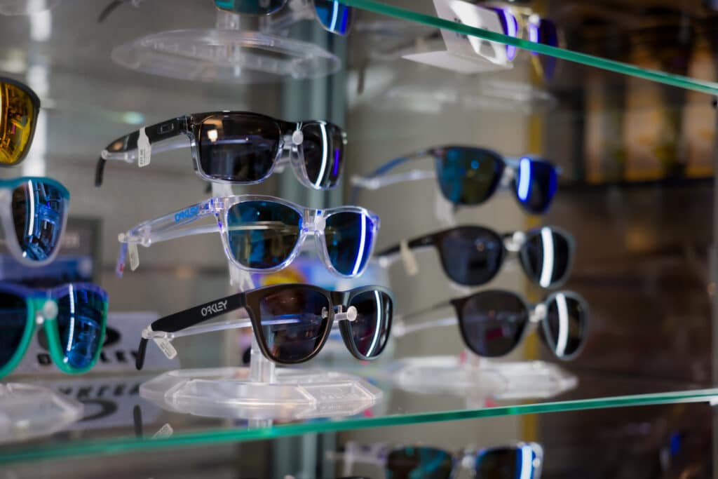 Sunglasses displayed on glass shelves for sale at Silver Saddle Gift Shop inside Golden Mesa Casino & Hotel.