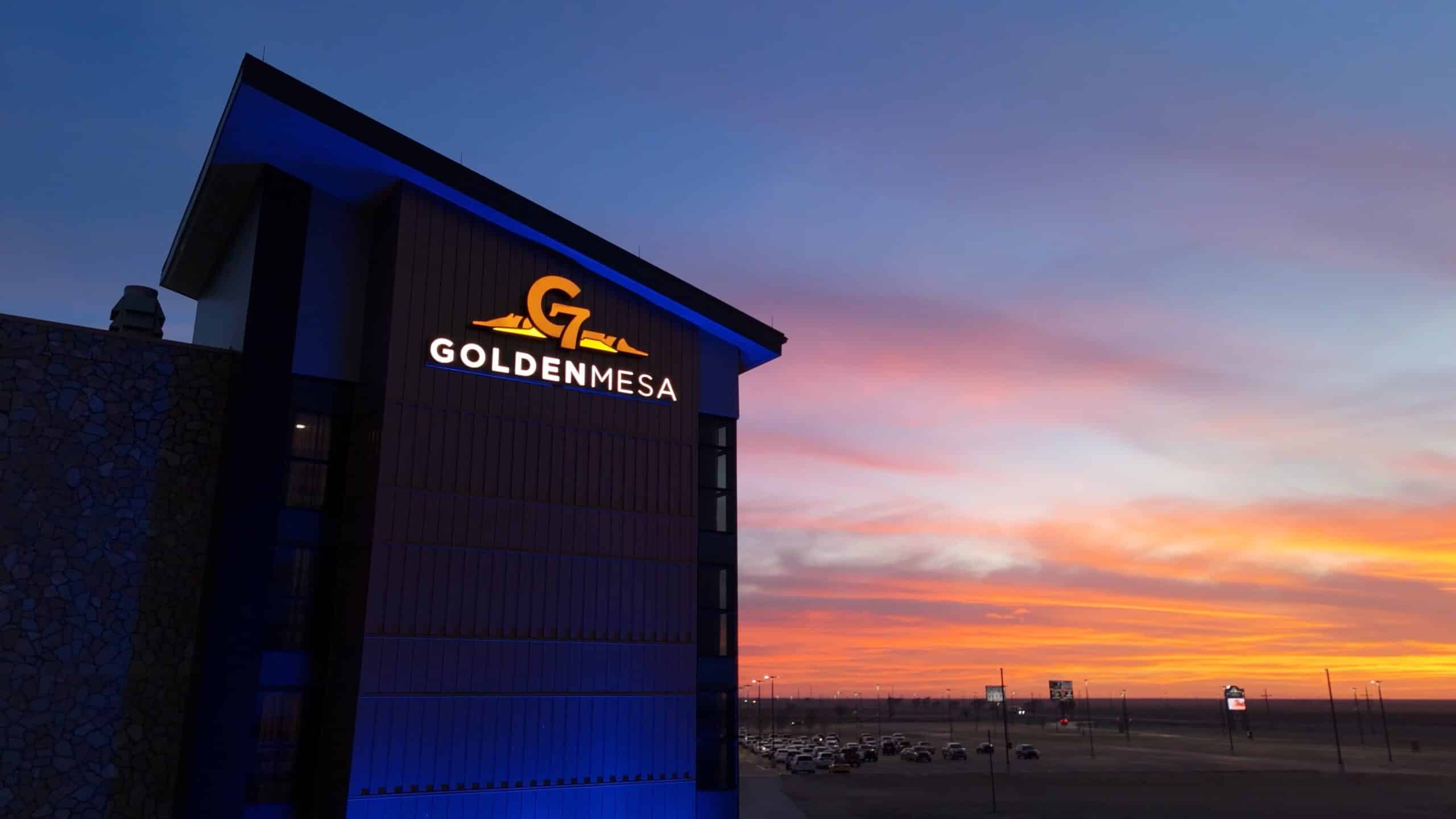Golden Mesa Casino & Hotel exterior sign glowing at sunset over the Guymon, Oklahoma skyline.