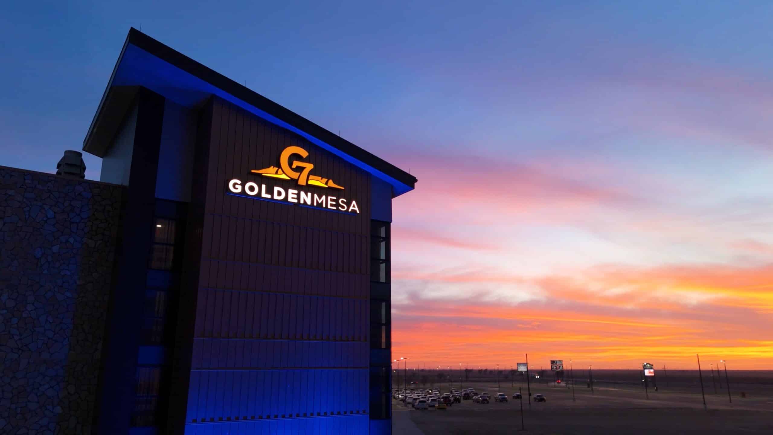 Golden Mesa Casino & Hotel exterior sign glowing at sunset over the Guymon, Oklahoma skyline.