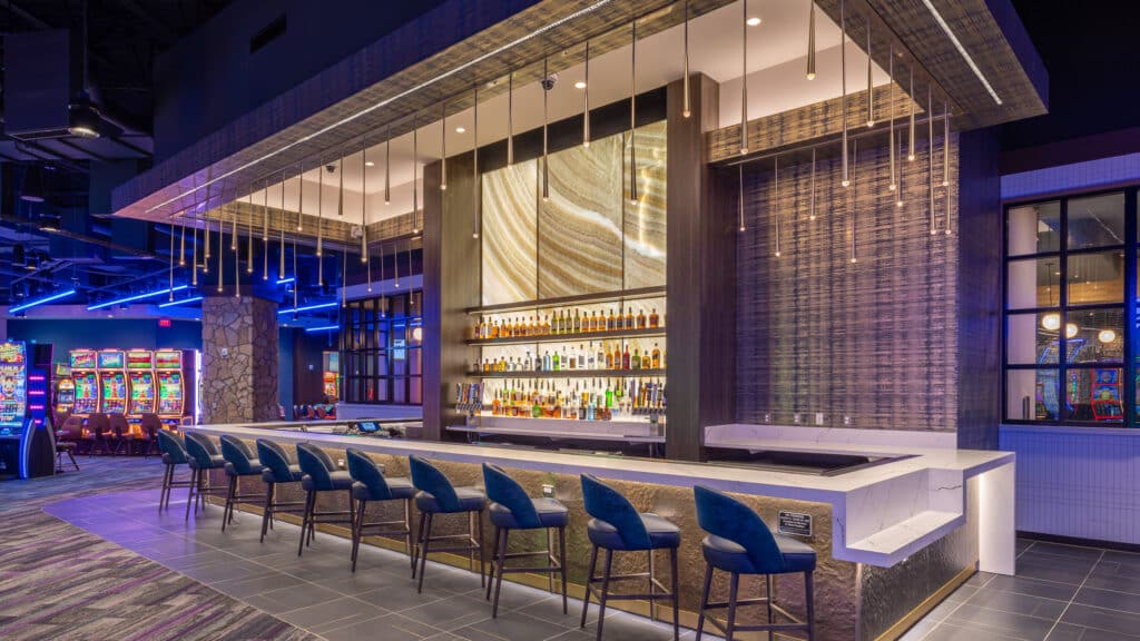 Cimarron Ridge Bar with polished seating, backlit shelves and access to the casino floor and restaurant at Golden Mesa Casino.