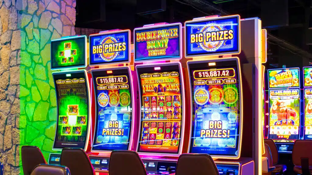 Colorful slot machines with “Big Prizes” screens and glowing lights on the Golden Mesa Casino gaming floor.