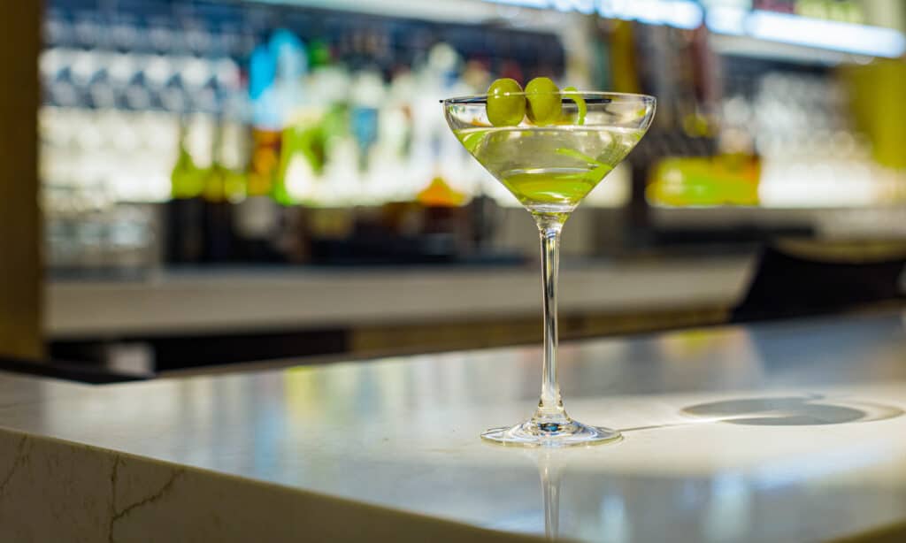 Classic dry martini with green olives resting on the bar at Cimarron Ridge Bar at Golden Mesa Casino & Hotel.