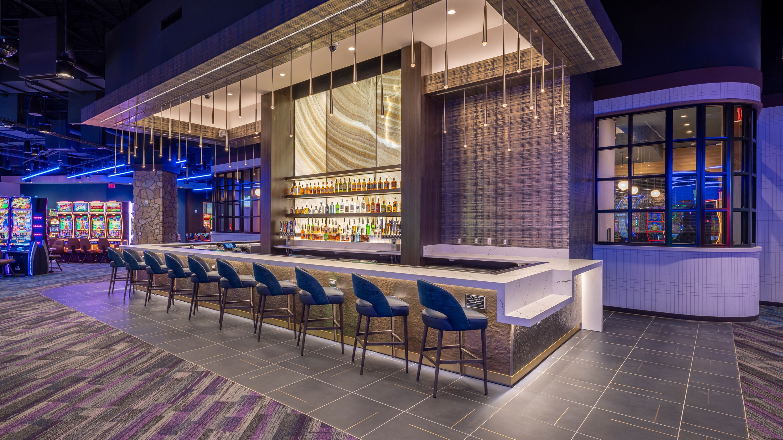 Cimarron Ridge Bar with polished seating, backlit shelves and access to the casino floor and restaurant at Golden Mesa Casino.