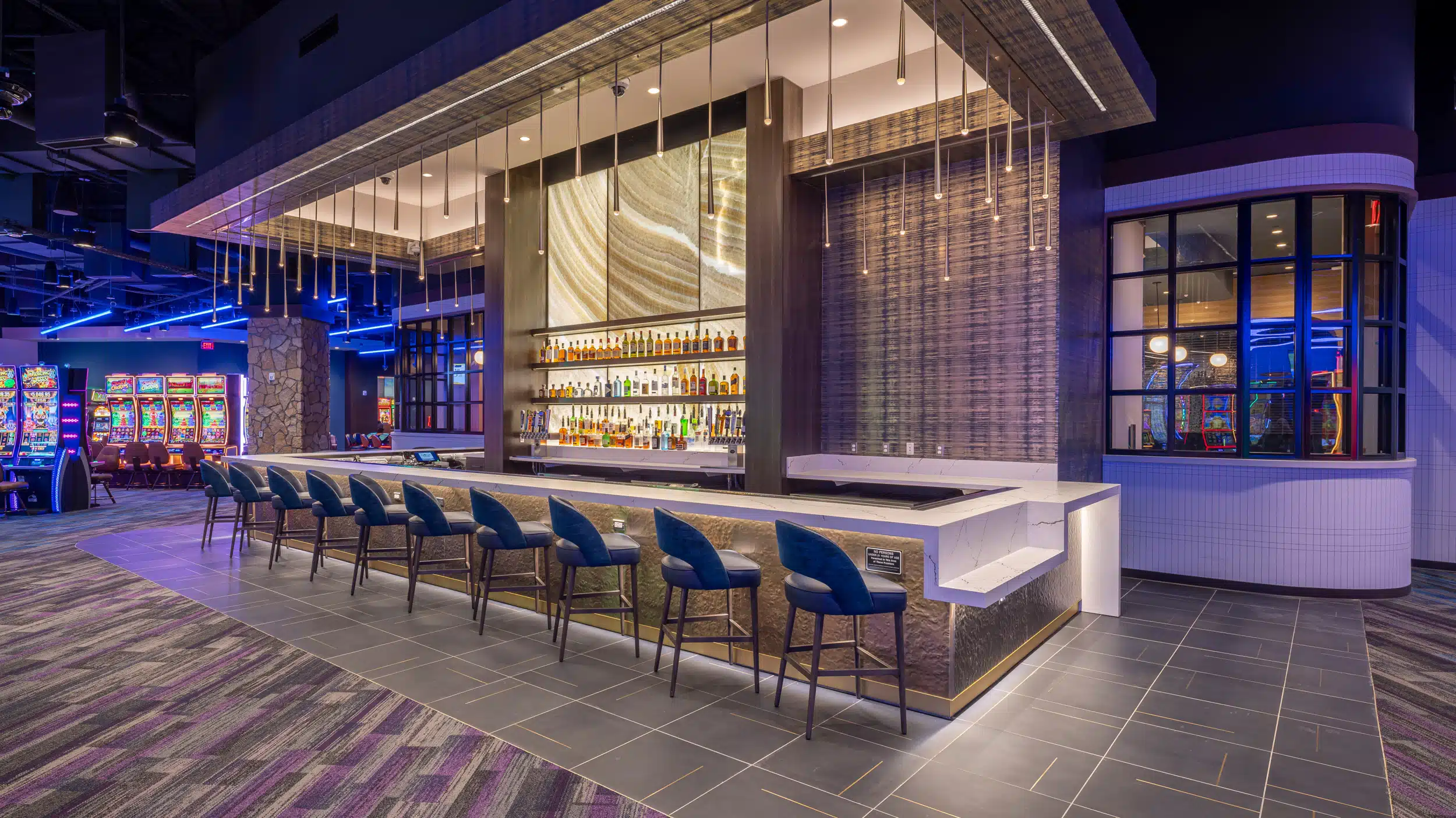 Cimarron Ridge Bar with polished seating, backlit shelves and access to the casino floor and restaurant at Golden Mesa Casino.