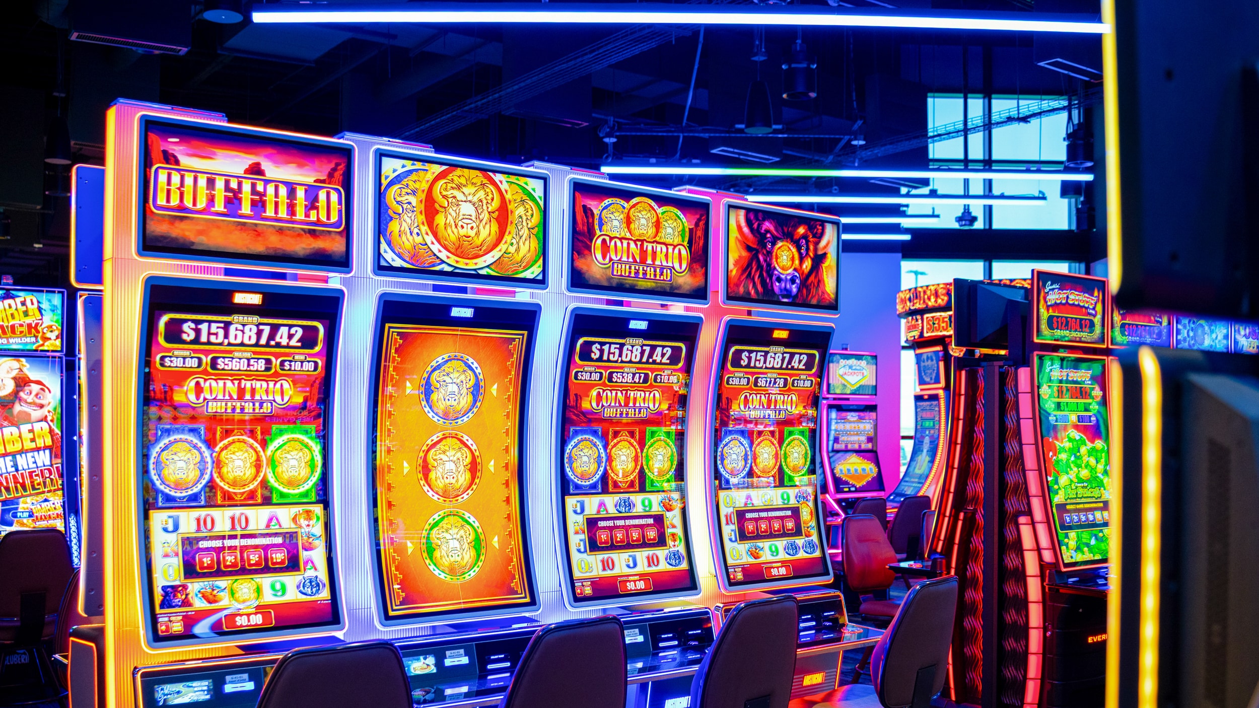 Bright electronic games and slot machines glowing with colorful screens on the Golden Mesa Casino gaming floor.