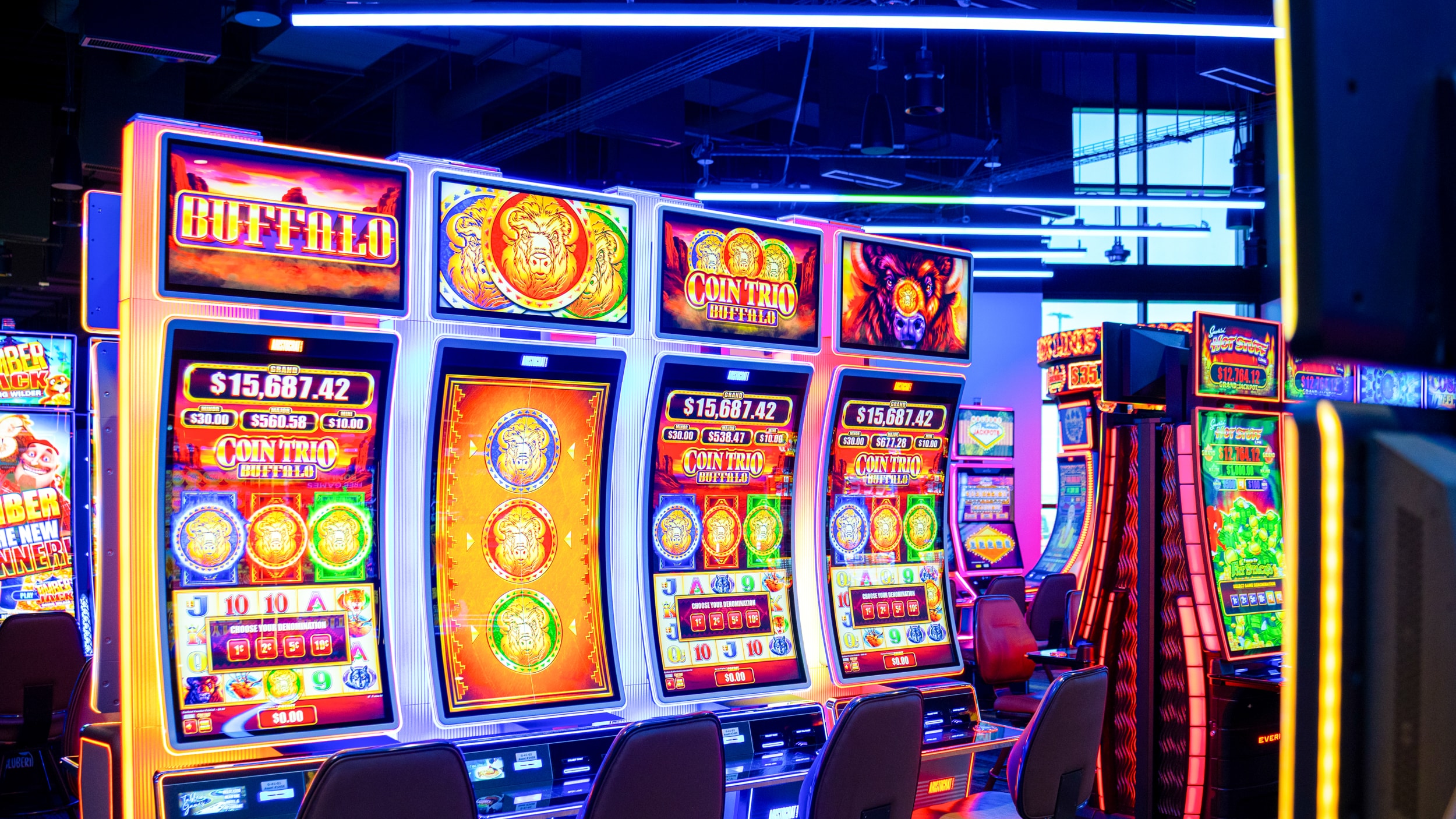 Bright electronic games and slot machines glowing with colorful screens on the Golden Mesa Casino gaming floor.